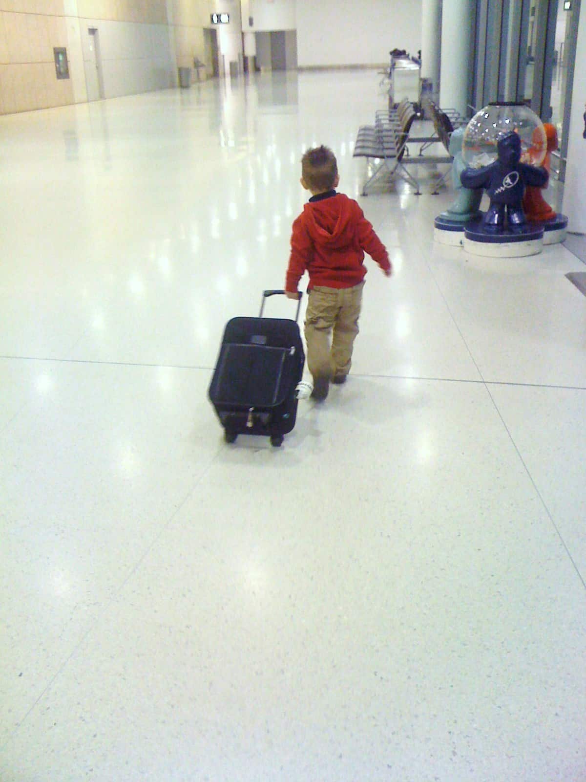 flying with a toddler, toddler, airport, suitcase, family travel, travel with toddler, traveling toddlers