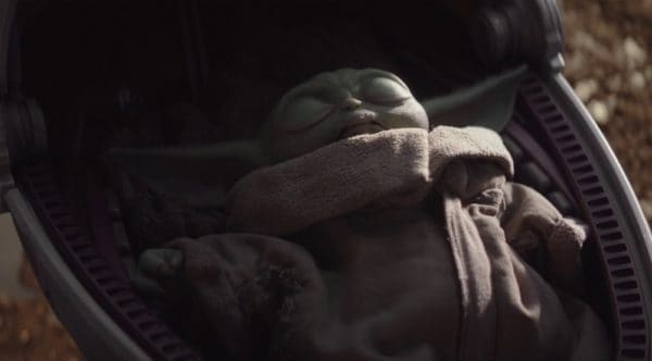 Baby Yoda asleep in his travel crib