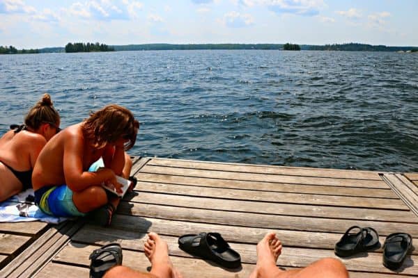 Reading on the dock on Stoney Lake at Viamede Resort